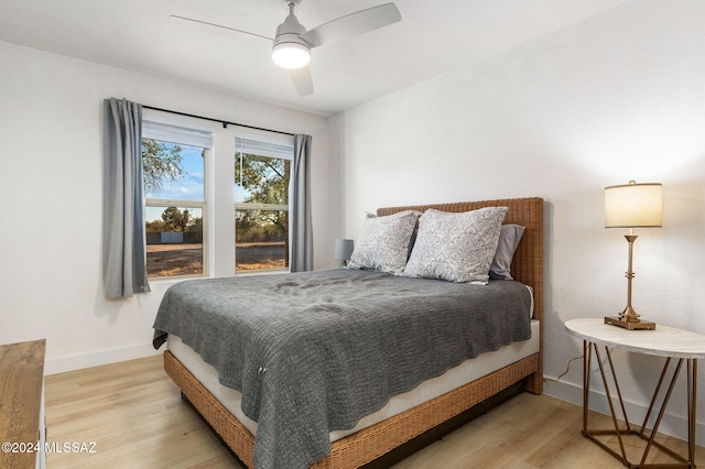 bedroom with ceiling fan and light hardwood / wood-style floors