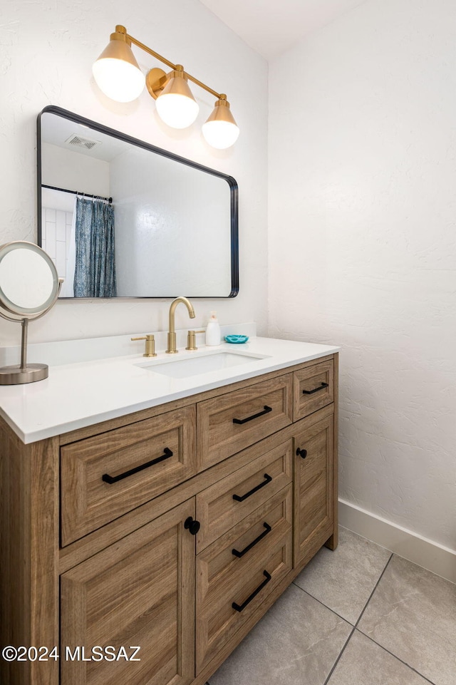 bathroom with tile patterned flooring and vanity