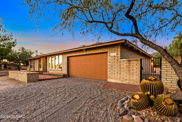 ranch-style home featuring a garage