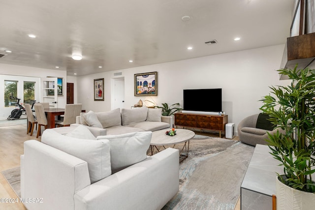 living room with french doors and light hardwood / wood-style flooring