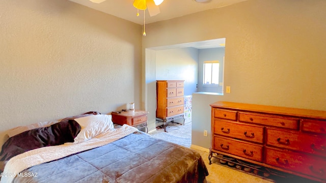 bedroom featuring carpet and a textured wall