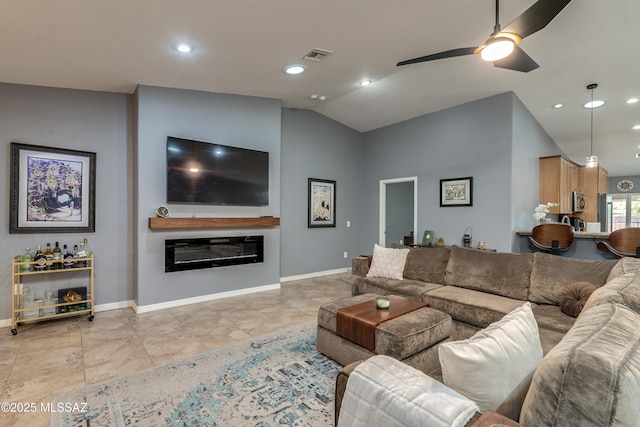 living room with ceiling fan and vaulted ceiling