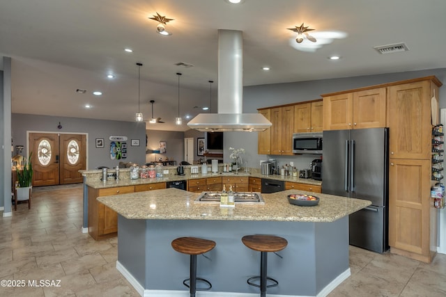 kitchen with stainless steel appliances, vaulted ceiling, a kitchen bar, island exhaust hood, and kitchen peninsula