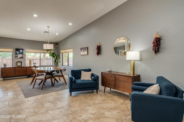 dining area with high vaulted ceiling