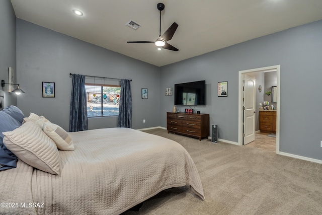 bedroom featuring vaulted ceiling, light colored carpet, ceiling fan, and connected bathroom