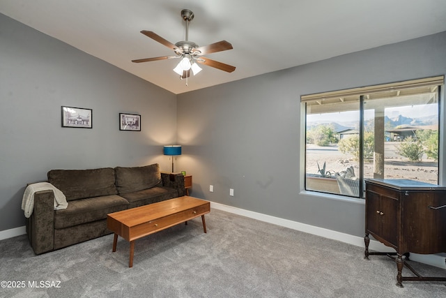 living room featuring ceiling fan, light carpet, and lofted ceiling