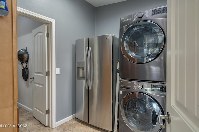 washroom featuring stacked washer / dryer and light tile patterned floors