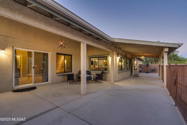 view of patio terrace at dusk