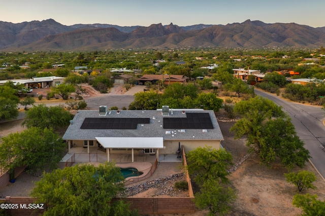 aerial view at dusk featuring a mountain view