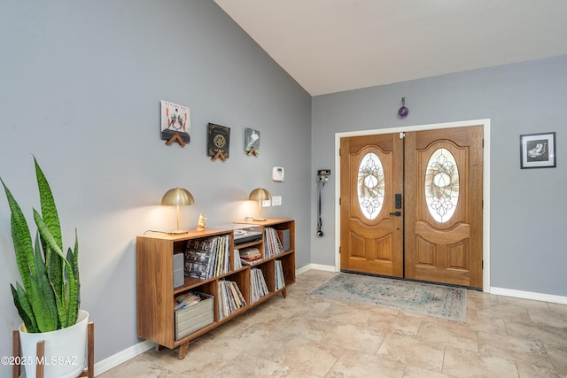 entrance foyer featuring french doors and lofted ceiling