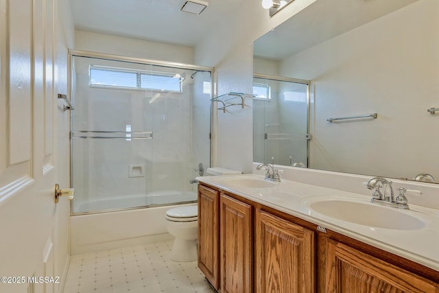 full bath with tile patterned floors, toilet, double vanity, and a sink