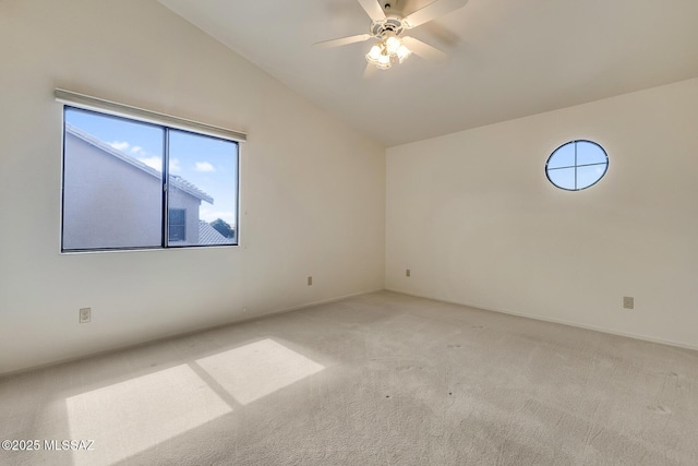 unfurnished room with vaulted ceiling, a ceiling fan, and light carpet