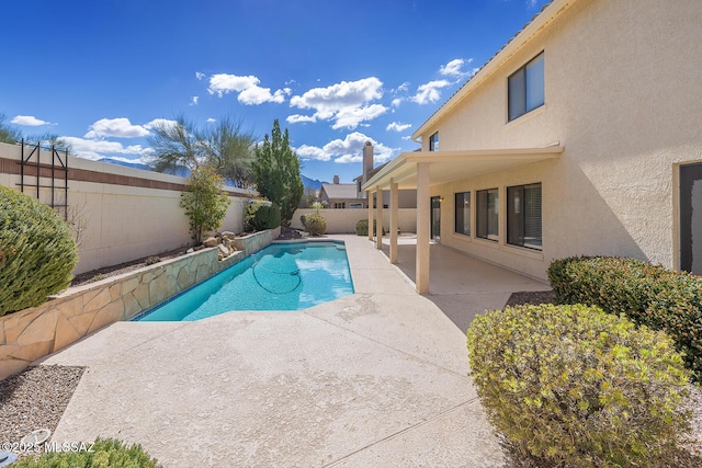 view of swimming pool featuring a patio area, a fenced in pool, and a fenced backyard