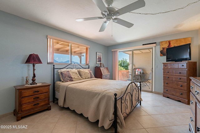 bedroom featuring ceiling fan, light tile patterned floors, access to outside, and multiple windows