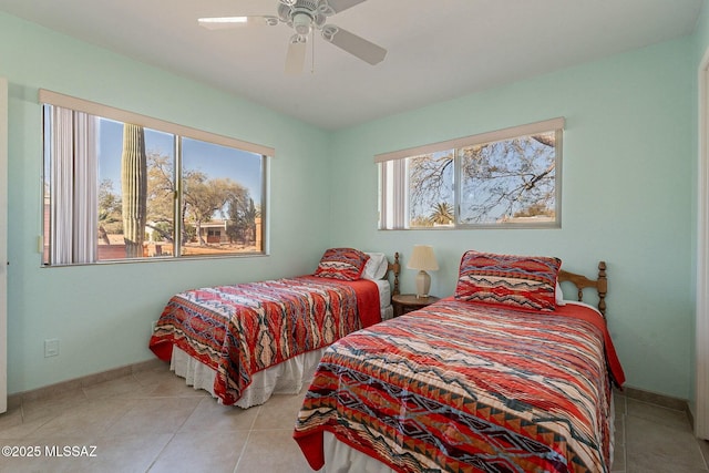 bedroom with ceiling fan and light tile patterned flooring