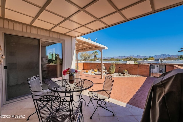 view of patio featuring a mountain view and a grill