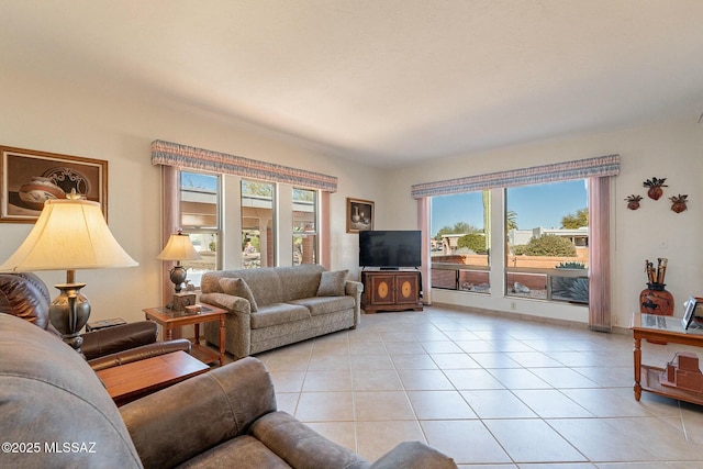 living room with light tile patterned floors and a wealth of natural light