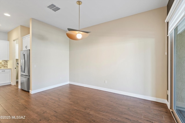 unfurnished room with recessed lighting, dark wood finished floors, visible vents, and baseboards