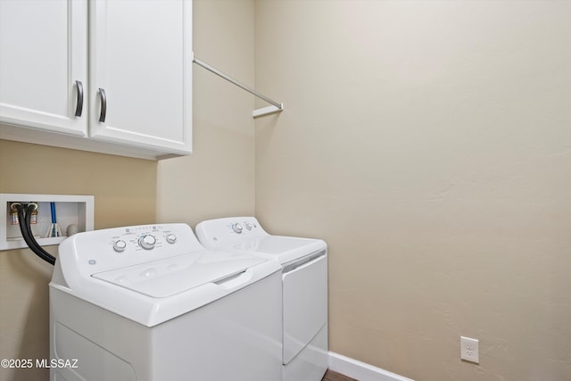 laundry area featuring cabinet space, baseboards, and washer and dryer