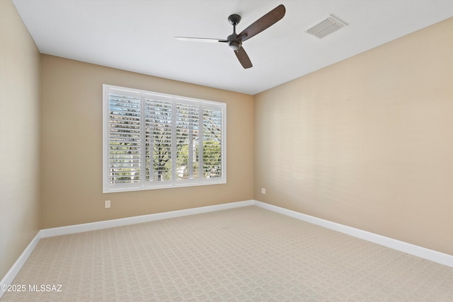 unfurnished room featuring carpet floors, baseboards, visible vents, and ceiling fan