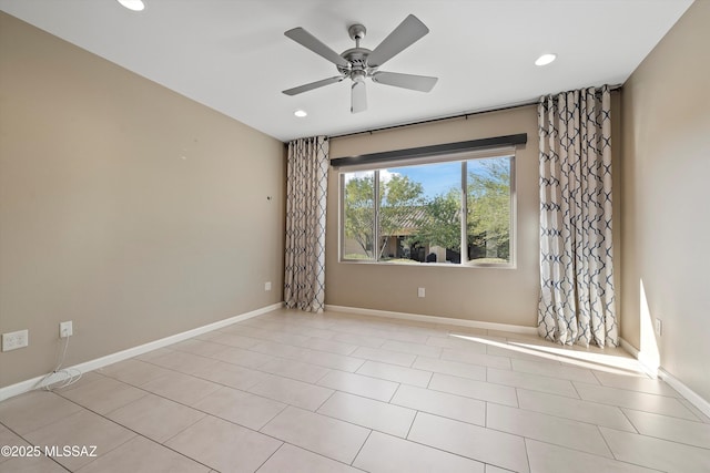 tiled empty room featuring ceiling fan