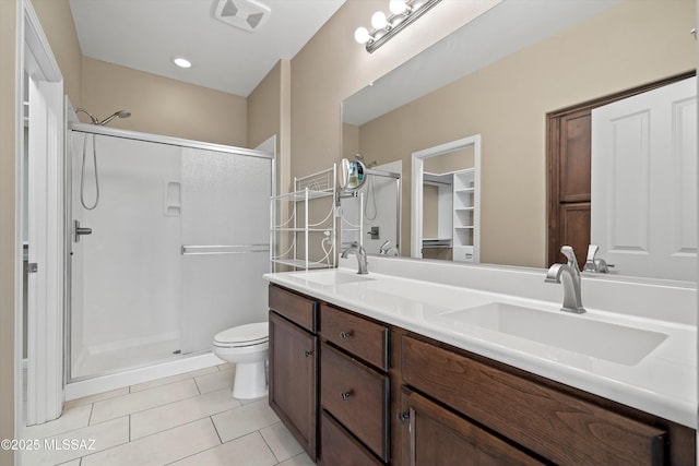 bathroom featuring vanity, toilet, tile patterned floors, and walk in shower