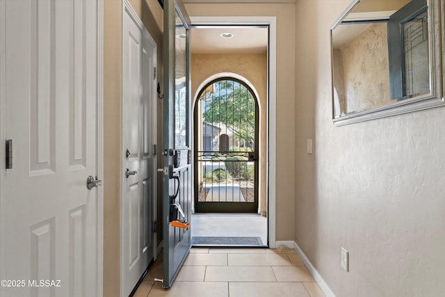 doorway to outside featuring light tile patterned flooring