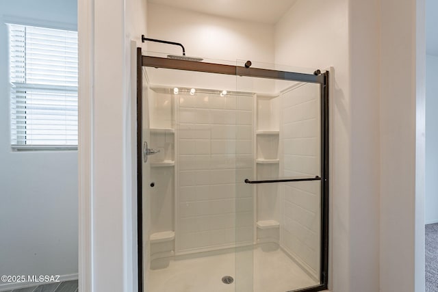 bathroom with a shower with shower door