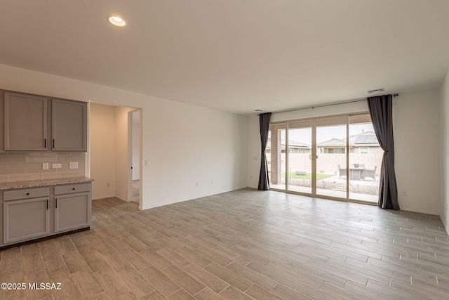 unfurnished living room featuring light hardwood / wood-style flooring