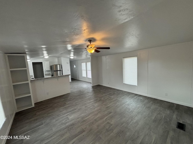 unfurnished living room with ceiling fan and dark hardwood / wood-style floors