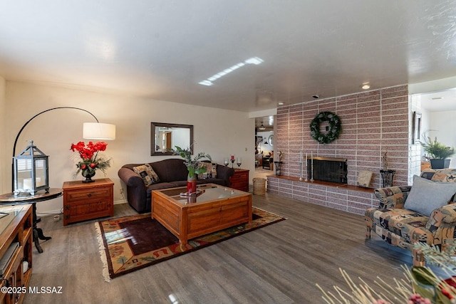 living room with a fireplace and dark wood-type flooring