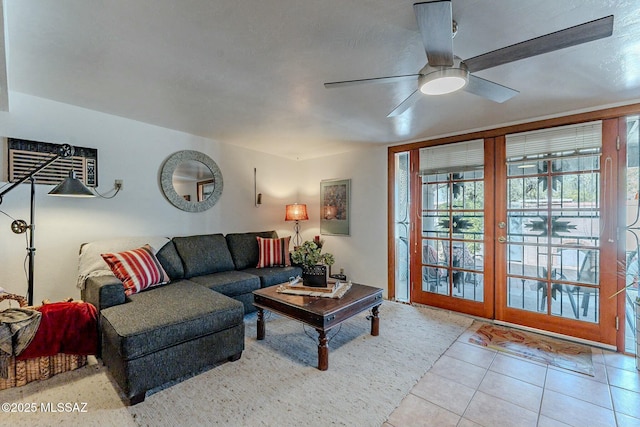 living room with ceiling fan, light tile patterned floors, and an AC wall unit