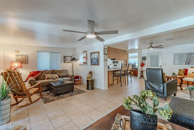 living room with ceiling fan and light tile patterned floors