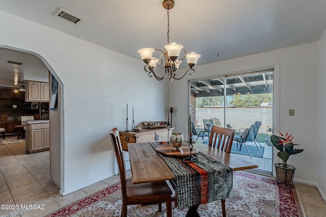 dining space with a notable chandelier and light tile patterned floors