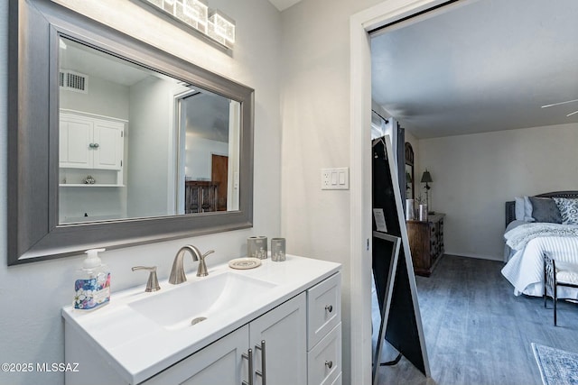 bathroom with hardwood / wood-style flooring and vanity