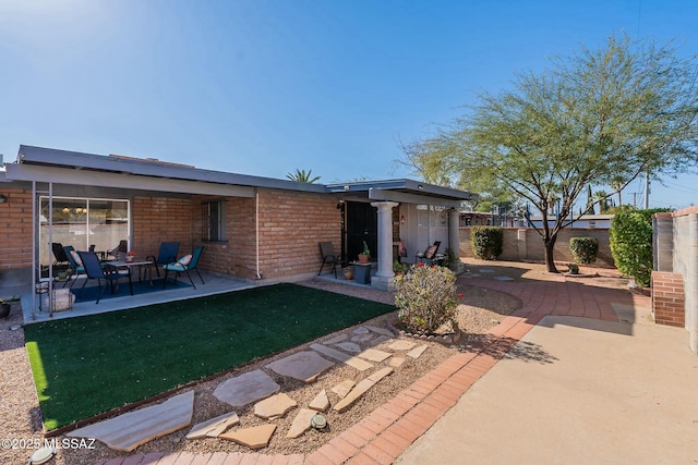 back of house with a yard and a patio area