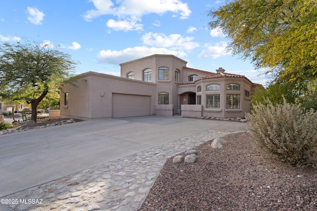 mediterranean / spanish house featuring a garage