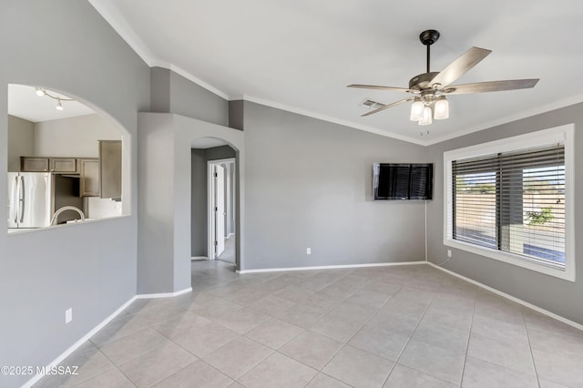 unfurnished room with light tile patterned floors, vaulted ceiling, ceiling fan, and crown molding