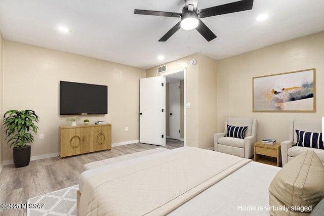 bedroom with ceiling fan and light hardwood / wood-style floors