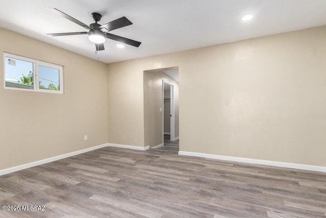 empty room featuring ceiling fan and hardwood / wood-style floors