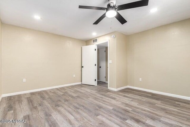 unfurnished room with ceiling fan and light wood-type flooring