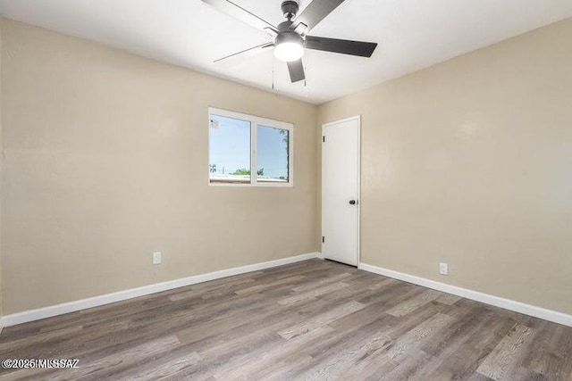 spare room featuring ceiling fan and wood-type flooring