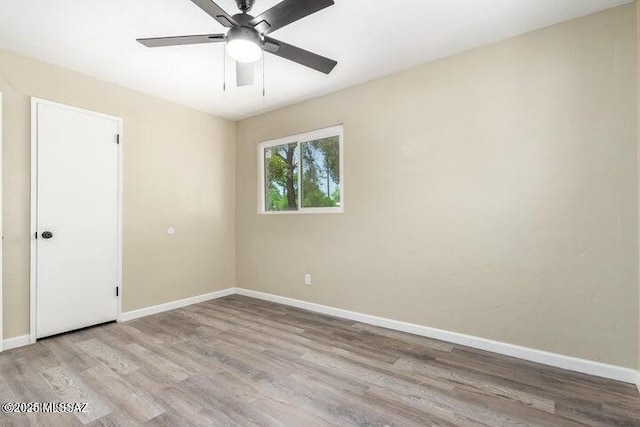 empty room featuring ceiling fan and light hardwood / wood-style flooring