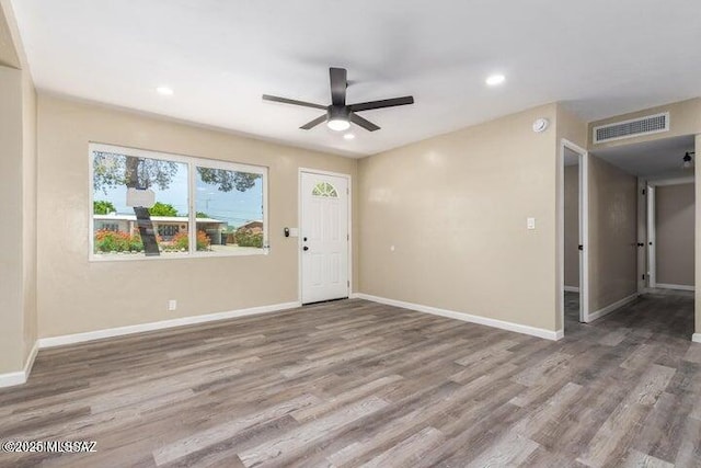 interior space with wood-type flooring and ceiling fan