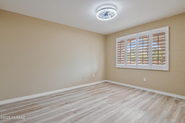 empty room with light hardwood / wood-style flooring