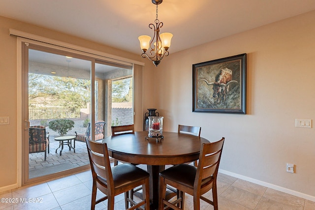 tiled dining space featuring a chandelier