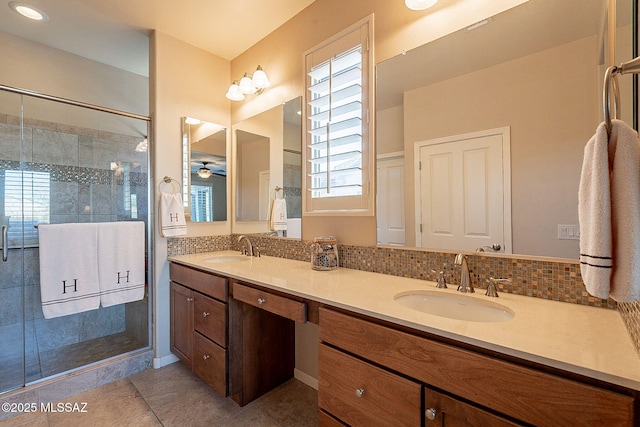 bathroom featuring vanity, tasteful backsplash, ceiling fan, and a shower with shower door