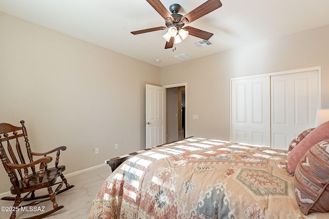 bedroom featuring ceiling fan, light colored carpet, and a closet