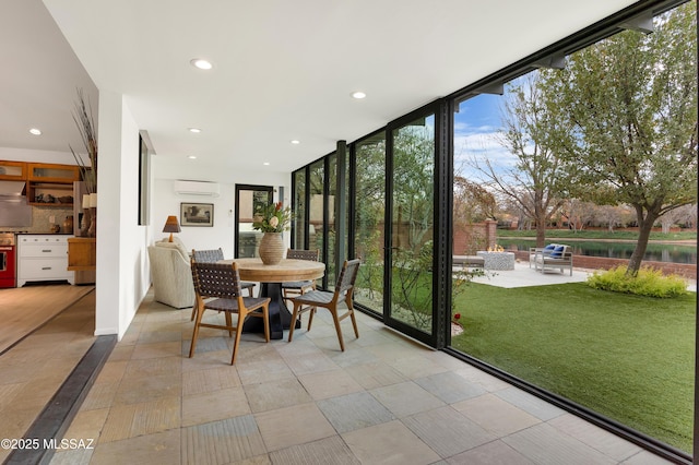 unfurnished sunroom featuring an AC wall unit