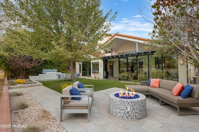 view of patio featuring an outdoor living space with a fire pit